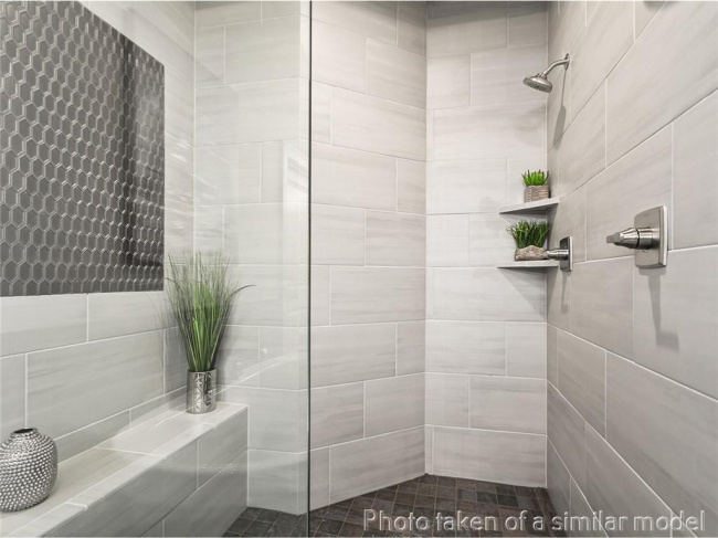 Full bath featuring tiled shower