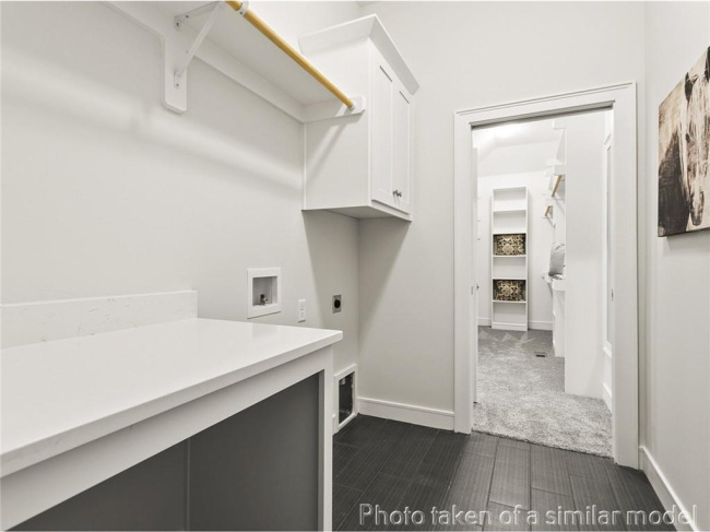 Laundry room featuring cabinet space, washer hookup, electric dryer hookup, and baseboards