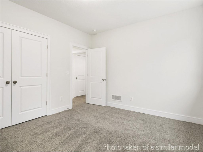 Unfurnished bedroom with carpet, baseboards, and a closet